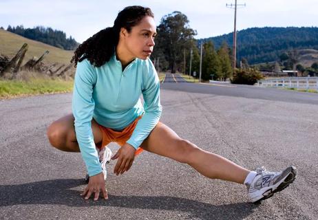 woman stretching after run