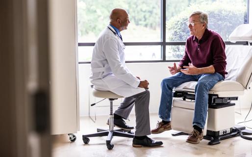 Doctor counseling older male patient