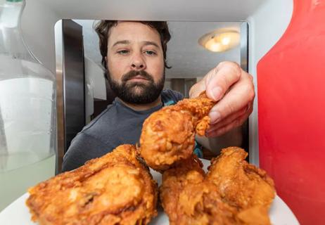 stressed man eating fried chicken