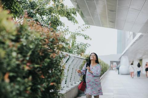 Person walking on walkway, swaying hands to music