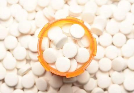 pill bottle surrounded by pills