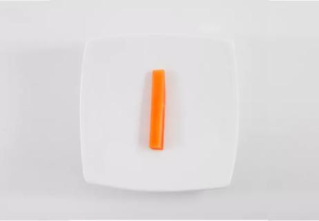 Lone carrot on a plate.