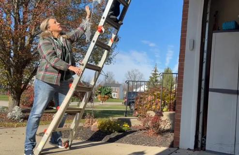 Woman climbing ladder