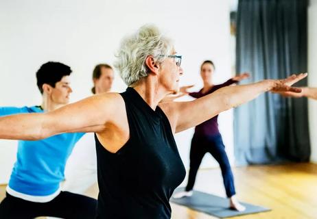 Older woman with leukemia in yoga class