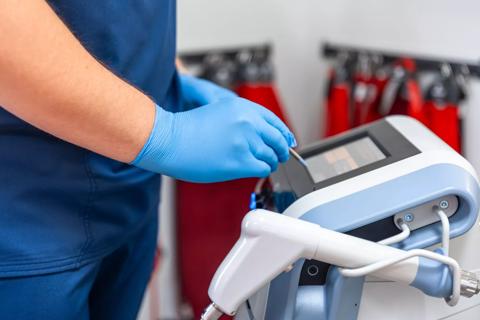 Healthcare provider using a shockwave therapy machine