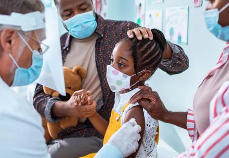 Child receiving vaccine at doctor's office