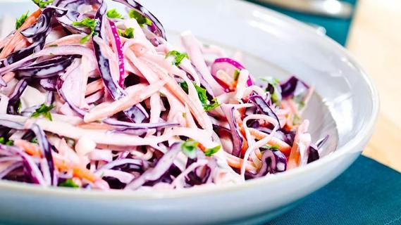 colorful cabbage slaw with basil in white bowl