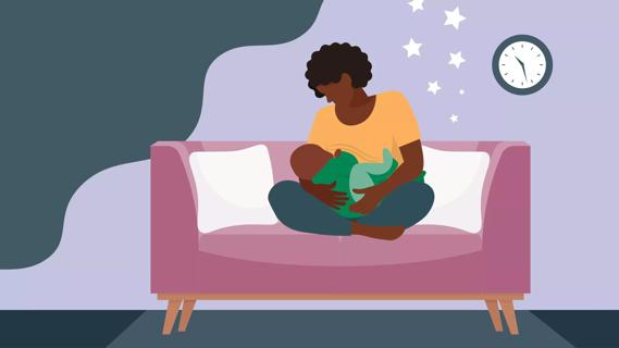 Woman breastfeeding baby on couch