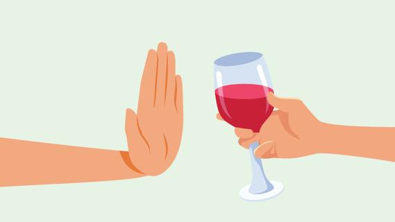 A hand waving off, declining a glass of wine being offered