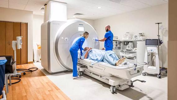 patient lying on imaging table about to enter machine