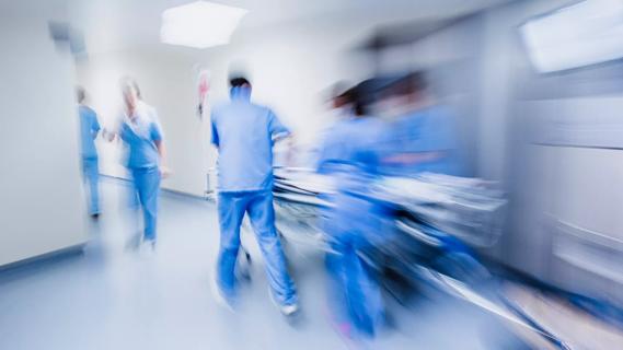 Nurses pushing gurney in hospital