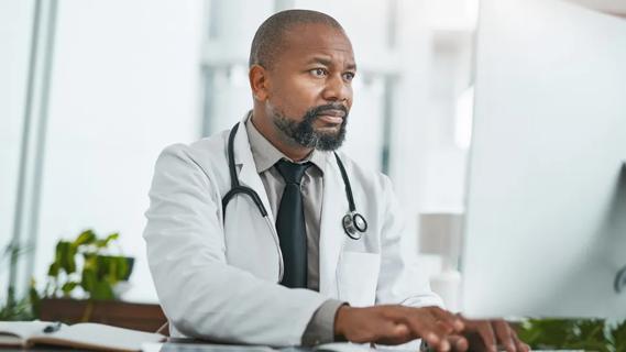 Physician looking at computer