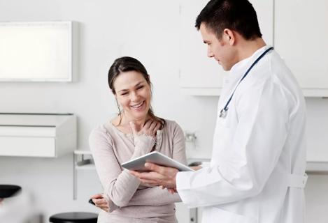 Doctor showing tablet screen to patient