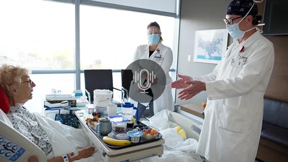 doctor speaking to a patient in a hospital bed