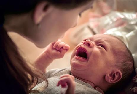 Mom comforting crying baby