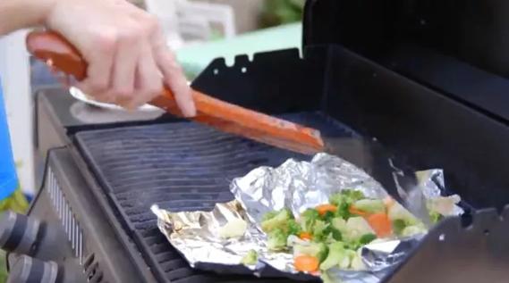 Man cooking on grill.