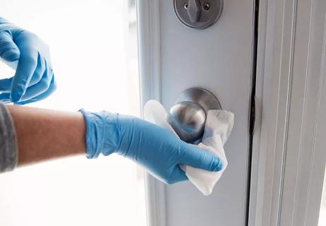 disinfecting wipes being used to clean doorknob