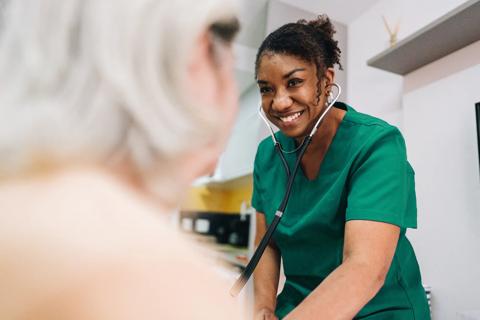 Caregiver smiling at elderly patient