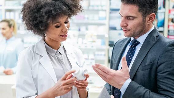 Male consults with pharmacist about herbal supplement