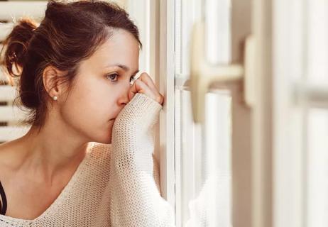 Worried girl staring out window