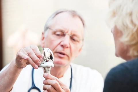 clinician showing model of knee to patient