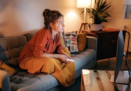 tense woman watching TV