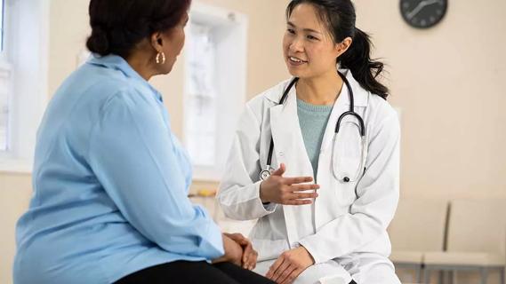 female healthcare provider speaking with patient in medical setting
