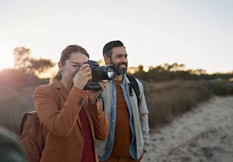 Woman and man taking pictures.