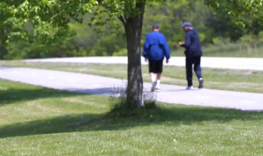 Men walking in park.