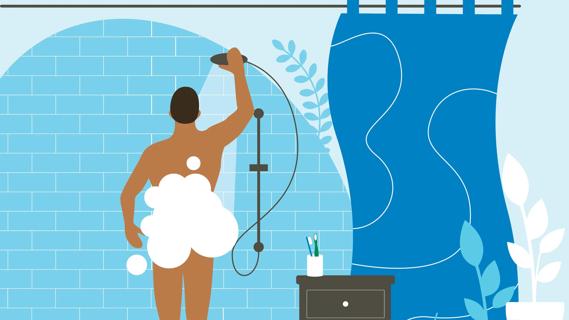 Person standing in shower, showering, with soapy bubbles