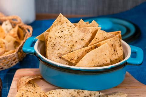 Baked garlic pita chips in blue bowl