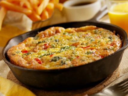 Vegetable frittata in iron skillet, with sweet potato fries