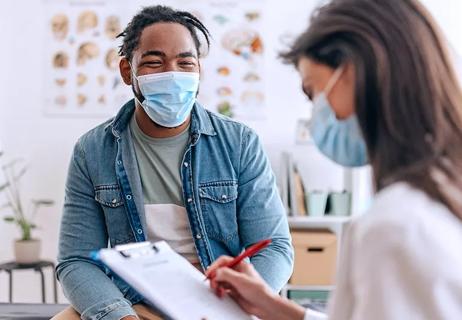 A patient talks with doctor during their office appointment.