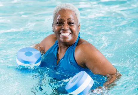 elderly woman exercises in water