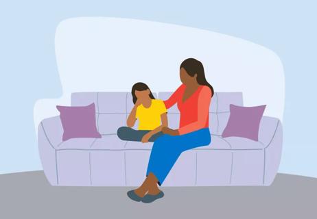 Parent and daughter sit on couch in home and discuss daily challenges.