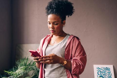 Woman looking at their cell phone