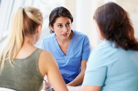 Nurse speaks with patients