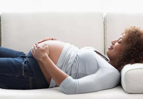 Pregnant woman lying on couch