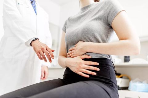 Patient holding upper abdomen