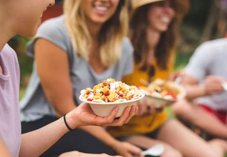 Group of friends eating yogurt bowls filled with fruit