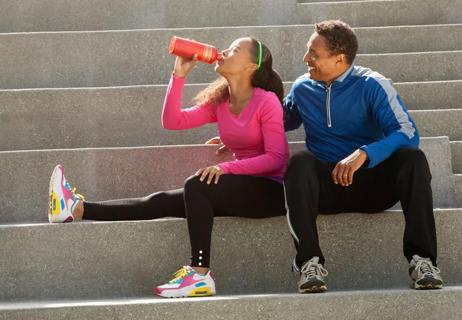 Father and daughter sitting on steps after running