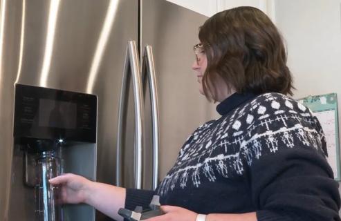 Person filling up water bottle