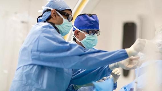 photo of cardiologists working in a cardiac catheterization lab