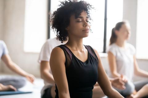 Person practicing deep breathing in yoga class