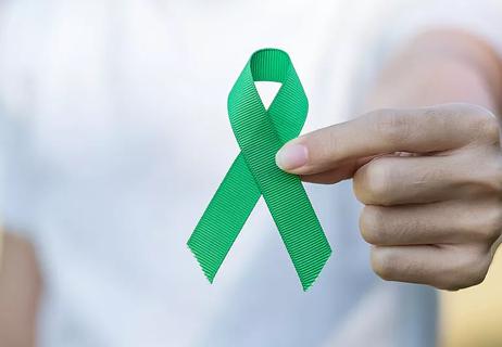 person holding a green ribbon