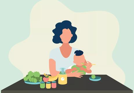 A person sits at a table with food and feeds their baby with a spoon