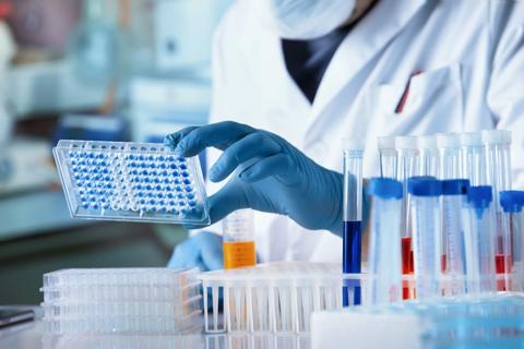 researcher with microplate