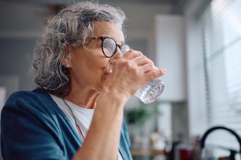 Older person drinking a glass of water