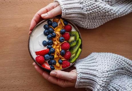 Bowl of Greek yogurt with fruit.