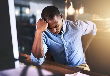 man at desk with back pain